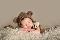 Baby newborn in bear hat snuggling a tiny bear, Sudbury newborn girl, stunning newborn baby photos.