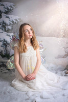 Light, snow fairy photos. Enchanting fine art bespoke fairy photography. Suffolk and Essex newborn and child photographer.