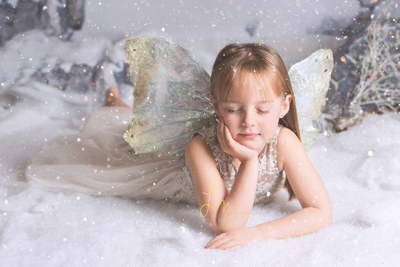 A little fairy dreaming in the snow. Fairy photoshoot, the snow fairy series.